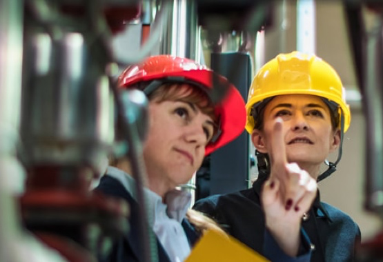 Women wearing hardhats in a factory